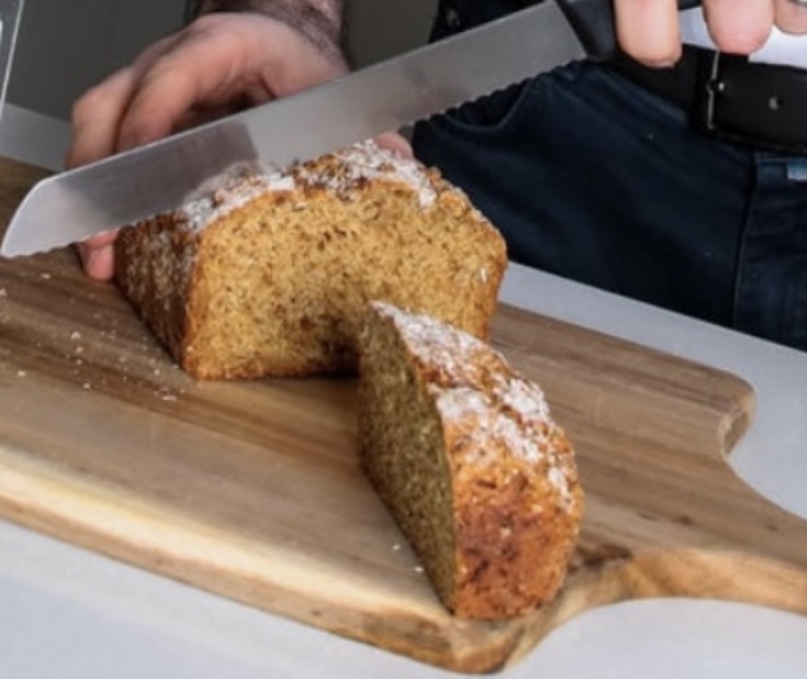image of The Brown Bread Guy cutting brown bread